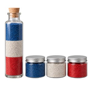 Tall cork-stoppered glass bottle filled with three layers of quartz sand, red at the bottom, Sea Pearl white in the middle and Ocean Depth royal blue on top, next to three closed clear jars with silver metal screw lids holding the same blue, white and red sand, on a white background.