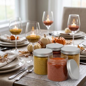 Autumn table centerpiece featuring wine glasses filled with Amber Gold and red quartz
sand holding tea light candles, designed for dry terrarium and table decor.