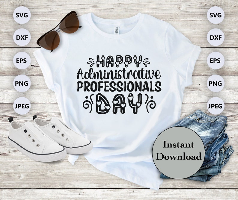 May include: A white t-shirt with the text "HAPPY Administrative PROFESSIONALS DAY" in black lettering with small hearts around the text. The shirt is on a wooden surface with sunglasses, white sneakers, and a stack of blue jeans.