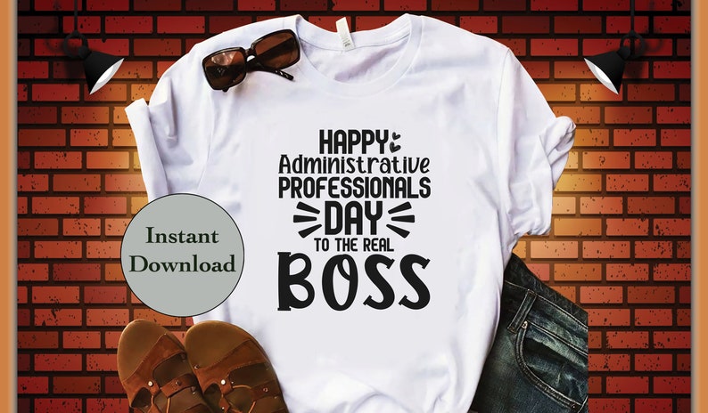 May include: White t-shirt with black text that reads "Happy Administrative Professionals Day to the Real Boss".