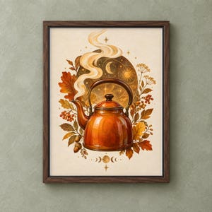 May include: A framed wall art print featuring a glossy orange tea kettle with steam rising from the spout. The kettle is surrounded by autumn leaves, berries, acorns, and a circular celestial background with a sun, moon, and stars in warm tones.