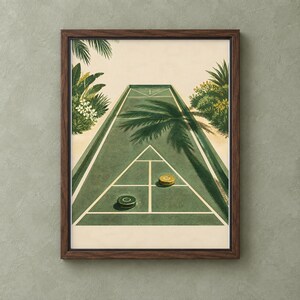 May include: A framed wall art print depicting a green shuffleboard court with white lines, two circular pucks in yellow and dark green, and lush tropical palm trees and foliage on both sides under a light cream-colored sky.