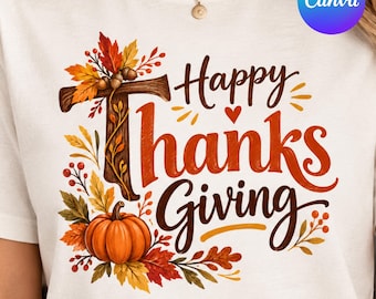 May include: A white t-shirt featuring a graphic print with the text Happy Thanksgiving in brown and orange script. The design includes a wooden letter T, a bright orange pumpkin, and colorful autumn leaves, berries, and acorns.