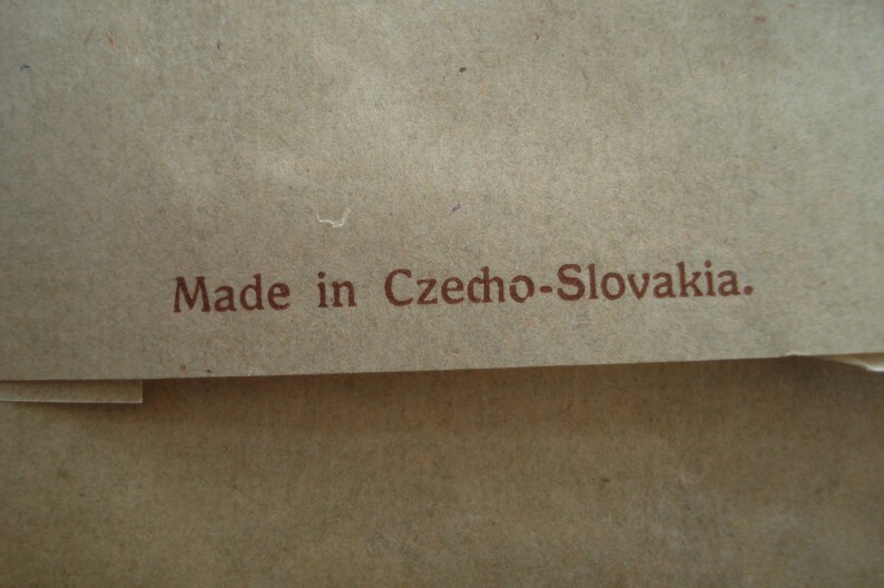 May include: A close-up of a brown paper bag with the text "Made in Czecho-Slovakia." printed in brown ink.