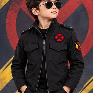 May include: A black utility jacket featuring a high collar, a full-length front zipper, and two chest pockets with flaps. The jacket displays a circular red and black X-Men logo on the left chest and a square yellow and red patch on the left sleeve.