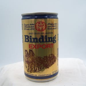 May include: A gold-colored Binding Export beer can with blue and white accents. The can features text and illustrations, including the words "Binding Export" in large letters. The can is 0.33 liters.