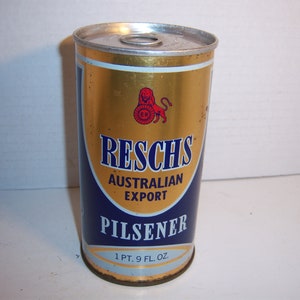 May include: A gold can of Reschs Australian Export Pilsener beer. The can has a blue band with the brand name and a red lion logo. The can is 1 pt. 9 fl. oz.