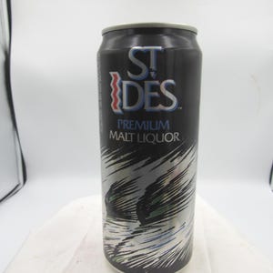 May include: A black St. Ides Premium Malt Liquor can with silver and white abstract design. The can features the brand name in white and blue, with a red accent. The can is cylindrical and has a silver top.