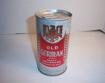 May include: A silver aluminum can of Old German Malt Beverage. The can has a red band with a gold eagle and the words "Old German" in a white font. The can is 12 fluid ounces.