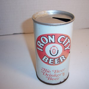 May include: A vintage aluminum can of Iron City Beer. The can is white with a red circle around the words "Iron City Beer". Inside the circle is a horseshoe with a crown and the letter "B". The bottom of the can says "The Beer Drinker's Beer".