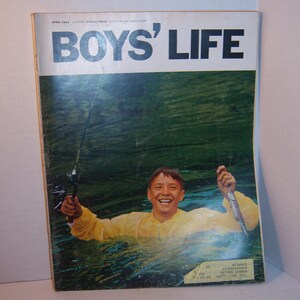 May include: Vintage April 1966 Boys' Life magazine cover. The cover features a smiling boy in a yellow raincoat, holding a fishing rod and a fish, submerged in water. The magazine title is in large white letters.