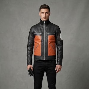 May include: A black and tan leather jacket featuring a high collar, a full-length silver front zipper, and four zippered pockets on the chest and waist. The jacket includes a circular white patch on the left sleeve and is paired with black pants.
