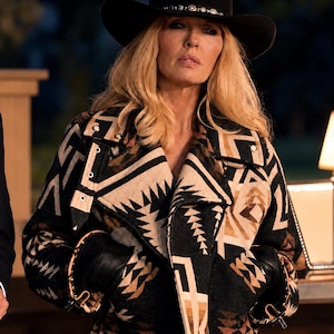 May include: A black felt cowboy hat with a silver-studded band and a heavy jacket featuring a geometric pattern in shades of black, tan, and cream. The jacket has a wide lapel, metal hardware, and black leather accents at the sleeve cuffs.
