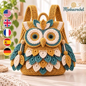 May include: A mustard yellow crochet backpack shaped like an owl, featuring large circular eyes with dark centers, a pointed beak, and layered feather-like appliques in teal, cream, and yellow. The bag includes two shoulder straps and the text Minhacrochet.