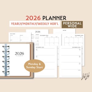 May include: A 2026 planner with a spiral binding, featuring yearly, monthly, and weekly layouts. The planner includes pages for tasks, calendars, and notes. The cover and pages are white with black text. The planner is labeled "Personal Wide."