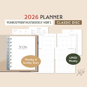 May include: A beige 2026 planner with a spiral binding, featuring yearly, monthly, and weekly layouts. The cover displays "2026 PLANNER" and "Monday & Sunday Start". Additional pages show calendars and lined weekly pages.