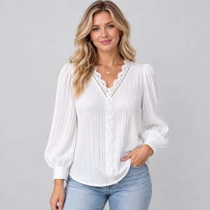 May include: A white long-sleeved blouse featuring a vertical pleated texture, a V-neckline trimmed with intricate white lace detailing, and full sleeves that gather at the wrist with buttoned cuffs, paired with light blue denim jeans.
