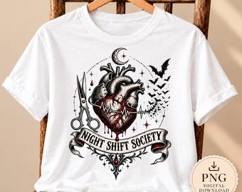 May include: A white t-shirt featuring a graphic illustration of an anatomical heart with a heartbeat line, a pair of scissors, a crescent moon, and a swarm of bats. Below the heart is a banner with the text NIGHT SHIFT SOCIETY in black.