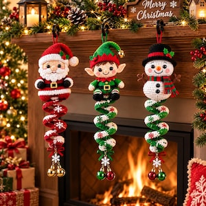 Può includere: Tre decorazioni natalizie all'uncinetto raffiguranti Babbo Natale, un elfo e un pupazzo di neve. Ogni figura poggia su una coda a spirale color bastoncino di zucchero, decorata con piccoli fiocchi di neve e due campanellini metallici pendenti.