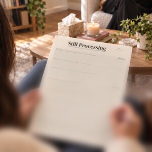 May include: A white paper worksheet titled Still Processing in black serif font. The document features structured sections with lines for writing, including prompts like Last time, Now I'm feeling, and What I don't want to forget to do.