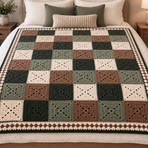 May include: A crochet blanket featuring a checkerboard pattern of square motifs in cream, sage green, dark forest green, and brown. The blanket is finished with a decorative border consisting of a dark green edge and a row of brown circles.