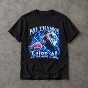 May include: A black short-sleeve t-shirt featuring a graphic print of a person in a suit holding a hand out toward a brain. The design includes blue lightning, a full moon, and the text NO THANKS I USE AI in a bold, icy blue font style.