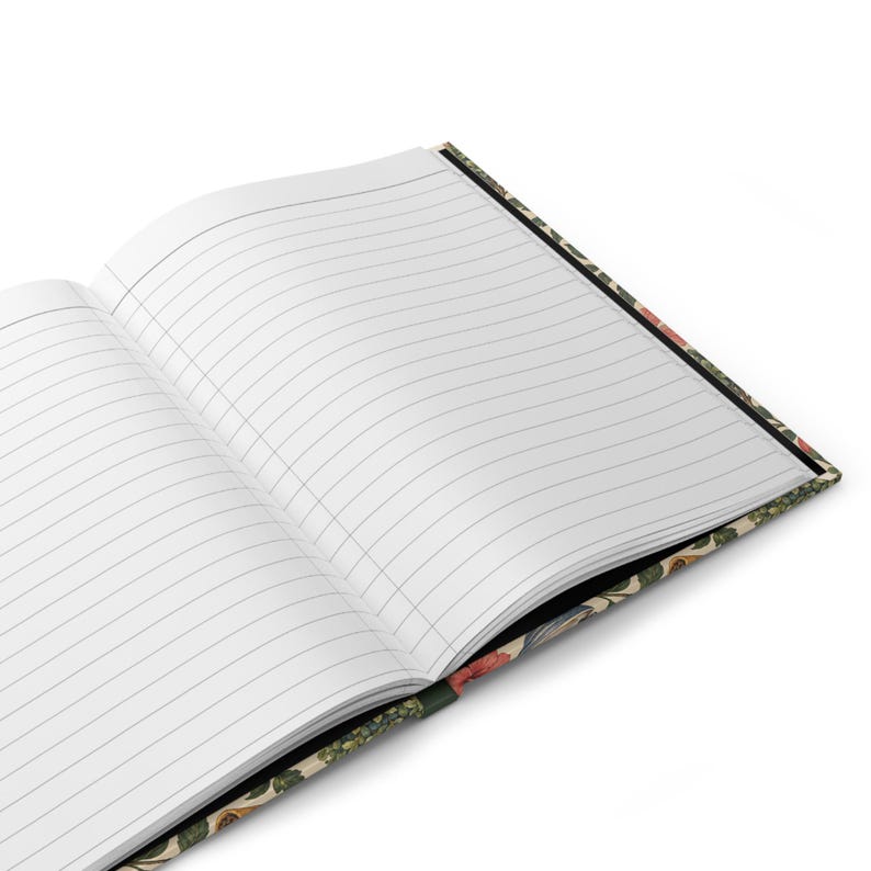 Supplier mockup of the journal opened to its lined interior. Two white ruled pages are shown at an angle, with a narrow edge of the illustrated hardcover visible underneath.