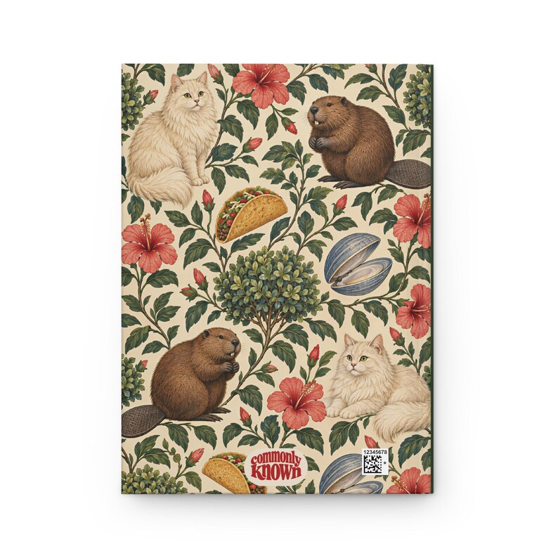 Back of the cream botanical hardcover journal, showing the repeating green foliage, cats, beavers, tacos, clams and pink flowers. Small red CommonlyKnown lettering sits in a rounded cream label near the bottom. Supplier product mockup.