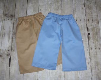May include: Two pairs of casual pants, one in a light brown color and the other in a light blue color.