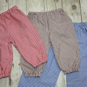 May include: Three pairs of checkered pants in red, brown, and blue. The pants are made of a soft, comfortable fabric and have a relaxed fit.