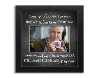 May include: Black framed photo with a quote about love and loss. The quote reads "Those we love don't go away, they WALK beside us EVERY day; unseen, unheard, but always NEAR, STILL Loved, STILL Missed & Very dear."