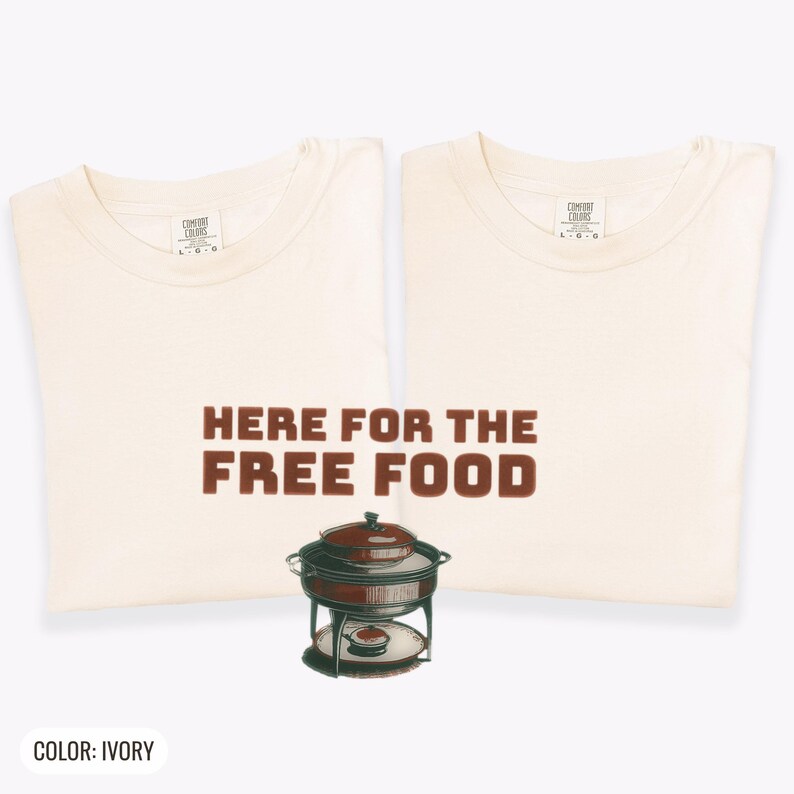 Ivory Comfort Colors t-shirt printed with the words Here For The Free Food and a drawing of a stainless steel chafing dish with steam rising off the lid, two matching shirts