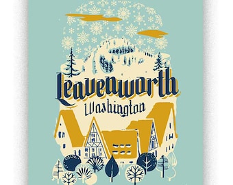 May include: A vintage-style illustration of a snowy mountain scene with the text "Leavenworth Washington" in a yellow and blue font. The illustration features a small town with houses and trees, and a background of snowflakes.