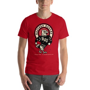 May include: Red short-sleeved t-shirt with a white circle graphic featuring a cartoon eagle wearing a sweater with the letters "EWU" on it. The circle graphic also includes the text "Eastern Eagles" and "Cheney, Washington".