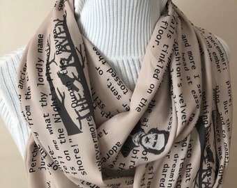 May include: A beige scarf with black text from Edgar Allan Poe's poem "The Raven". The text includes the lines "Tell me what thy lordly name is on the Night's Plutonian shore!" and "Quoth the Raven "Nevermore."