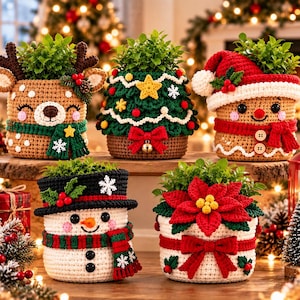 May include: Five crocheted plant pot covers featuring holiday designs: a tan reindeer with a green scarf, a green Christmas tree with a yellow star, a tan gingerbread person with a Santa hat, a white snowman with a black hat, and a white pot with a red poinsettia.
