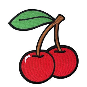 May include: Embroidered patch featuring two red cherries with brown stems and a green leaf. The cherries have a black outline and a white highlight, creating a 3D effect. The patch is likely for clothing or accessories.