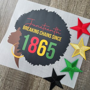 May include: A black and white illustration of a woman's face with an afro hairstyle. The text "Juneteenth Breaking Chains Since 1865" is written in red, yellow, and green. There are five colorful star-shaped patches in the background.