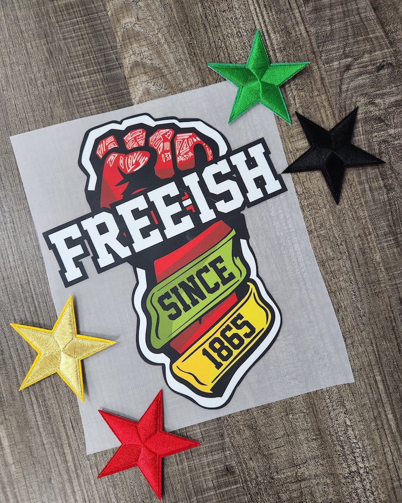 May include: A red fist raised in the air with the text "FREE-ISH SINCE 1865" in white and yellow. The fist is surrounded by a green and yellow banner.