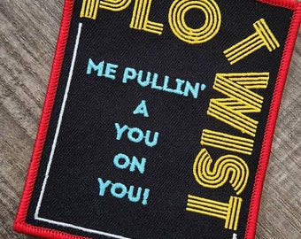 May include: Black and yellow embroidered patch with the text "PLOT TWIST" and the phrase "ME PULLIN' A YOU ON YOU!"