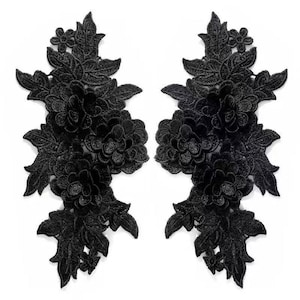 May include: Two black floral lace appliques. Each applique features a detailed design of flowers and leaves. The appliques are symmetrical and suitable for various craft projects.