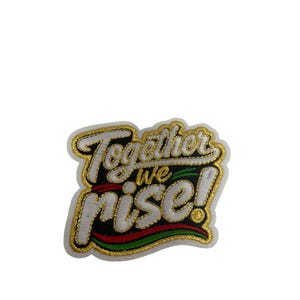 May include: An embroidered patch featuring the text Together we rise! in white lettering with a gold border. The design includes a black background with a curved red and green stripe underneath the word rise, all outlined in gold thread.