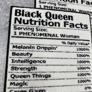 May include: White rectangular rug with black text that reads "Black Queen Nutrition Facts." The rug lists "Melanin Drippin'," "Beauty," "Intelligence," "Strength," "Queen Things," and "Magic" with 1000% daily value.