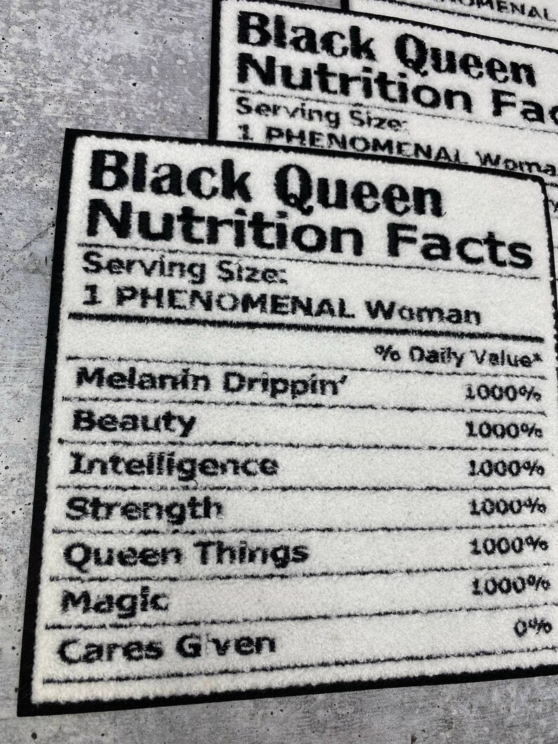 May include: White rectangular rug with black text that reads "Black Queen Nutrition Facts." The rug lists "Melanin Drippin'," "Beauty," "Intelligence," "Strength," "Queen Things," and "Magic" with 1000% daily value.