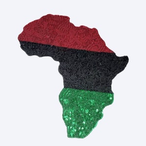 May include: A red, black, and green sequined outline of the continent of Africa.