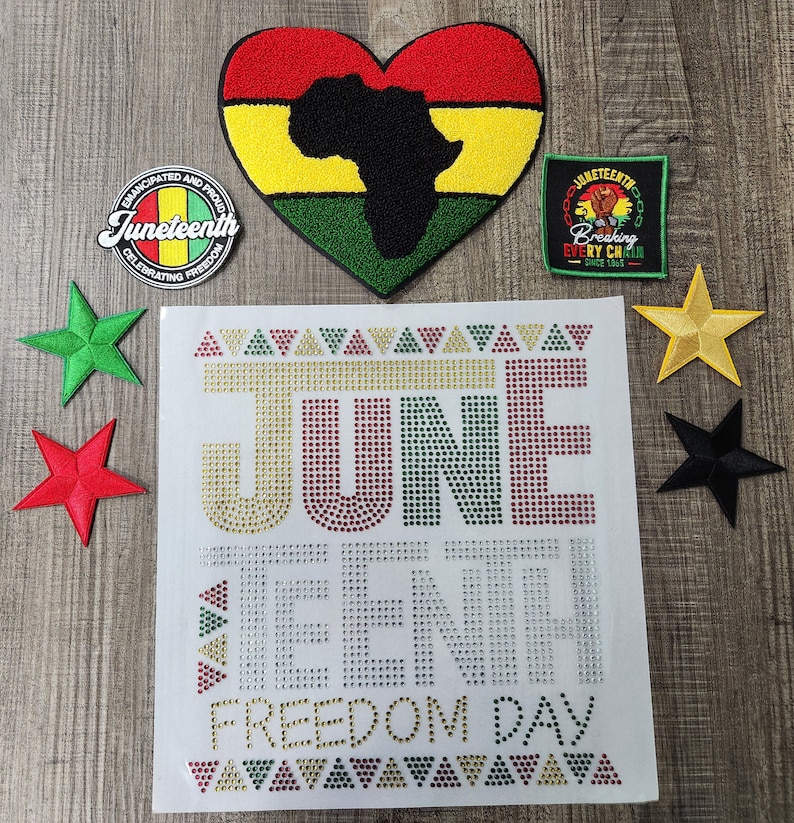 May include: A white background with a red, yellow, and green heart-shaped patch with a black outline of the continent of Africa.  The text "Juneteenth" is in a red, yellow, and green circle with a black outline.  The text "Breaking Every Chain Since 1865" is in a red, yellow, and green rectangle with a black outline.  The text "JUNE TEENTH FREEDOM DAY" is in a large font with red, yellow, and green rhinestones.  The text is surrounded by a border of red, yellow, and green triangles.