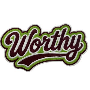 May include: An embroidered patch featuring the word Worthy in a dark maroon script font. The text is outlined with a bright lime green border, followed by a thick white outer edge, creating a layered, bold appearance with a textured finish.