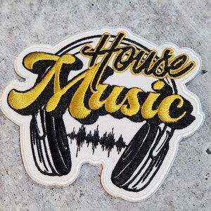 May include: Embroidered patch with the words "House Music" in gold and black, featuring a stylized headphone design. The patch has a white border and a sound wave graphic.