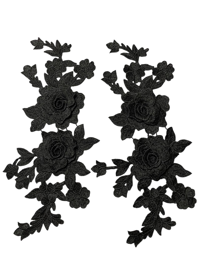May include: Two black floral lace appliques. Each applique features a large rose surrounded by leaves and smaller flowers. The appliques are intricately detailed and suitable for embellishing garments or crafts.