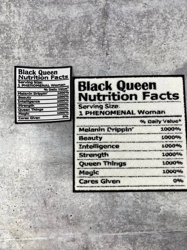 May include: Two white rectangular patches with black text that reads "Black Queen Nutrition Facts." The patches list "Melanin Drippin'," "Beauty," "Intelligence," "Strength," "Queen Things," and "Magic" with 1000% daily value.